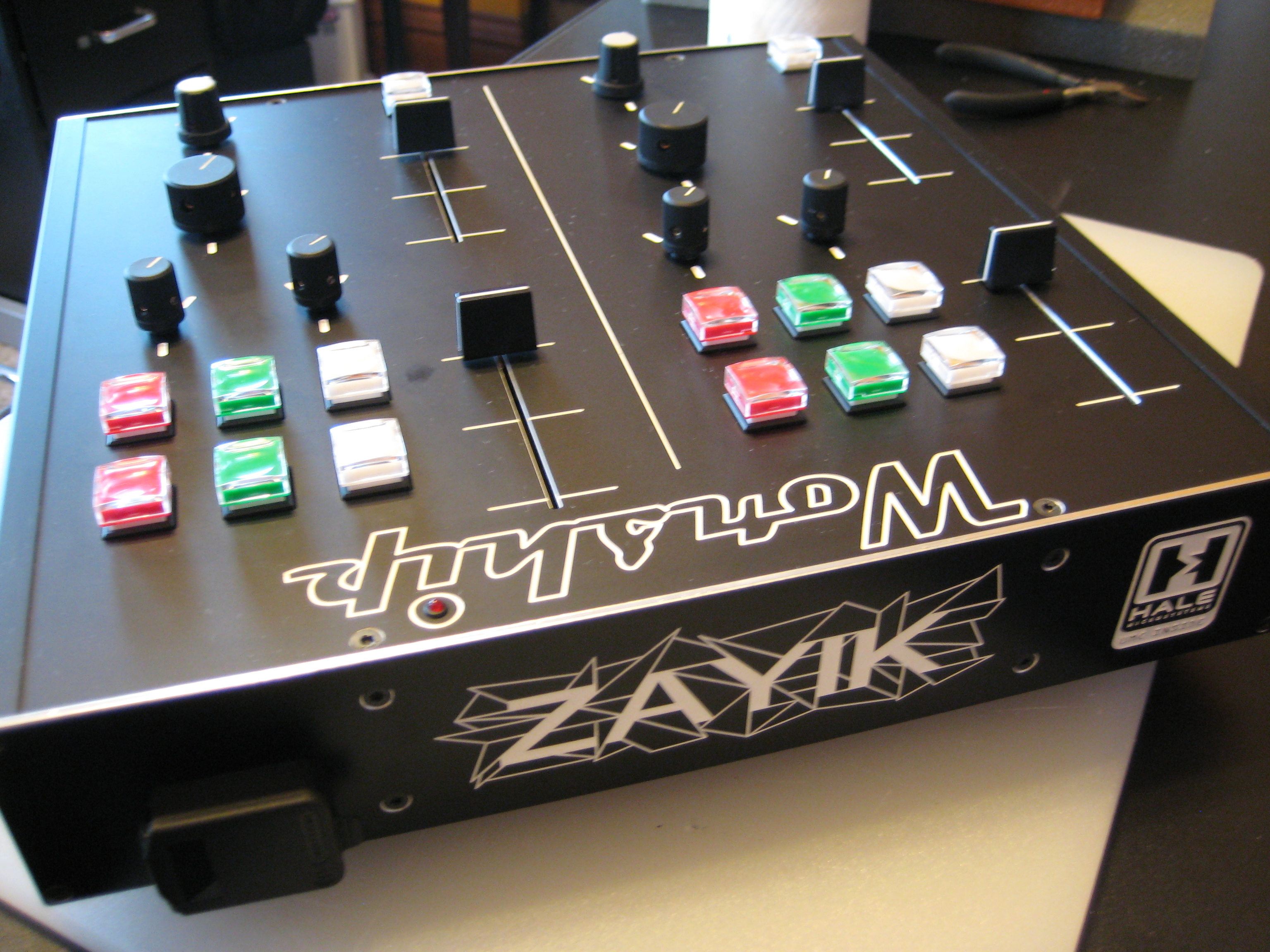Black ZAYIK Worship DJ-style mixer with illuminated red, green and white buttons, knobs and faders